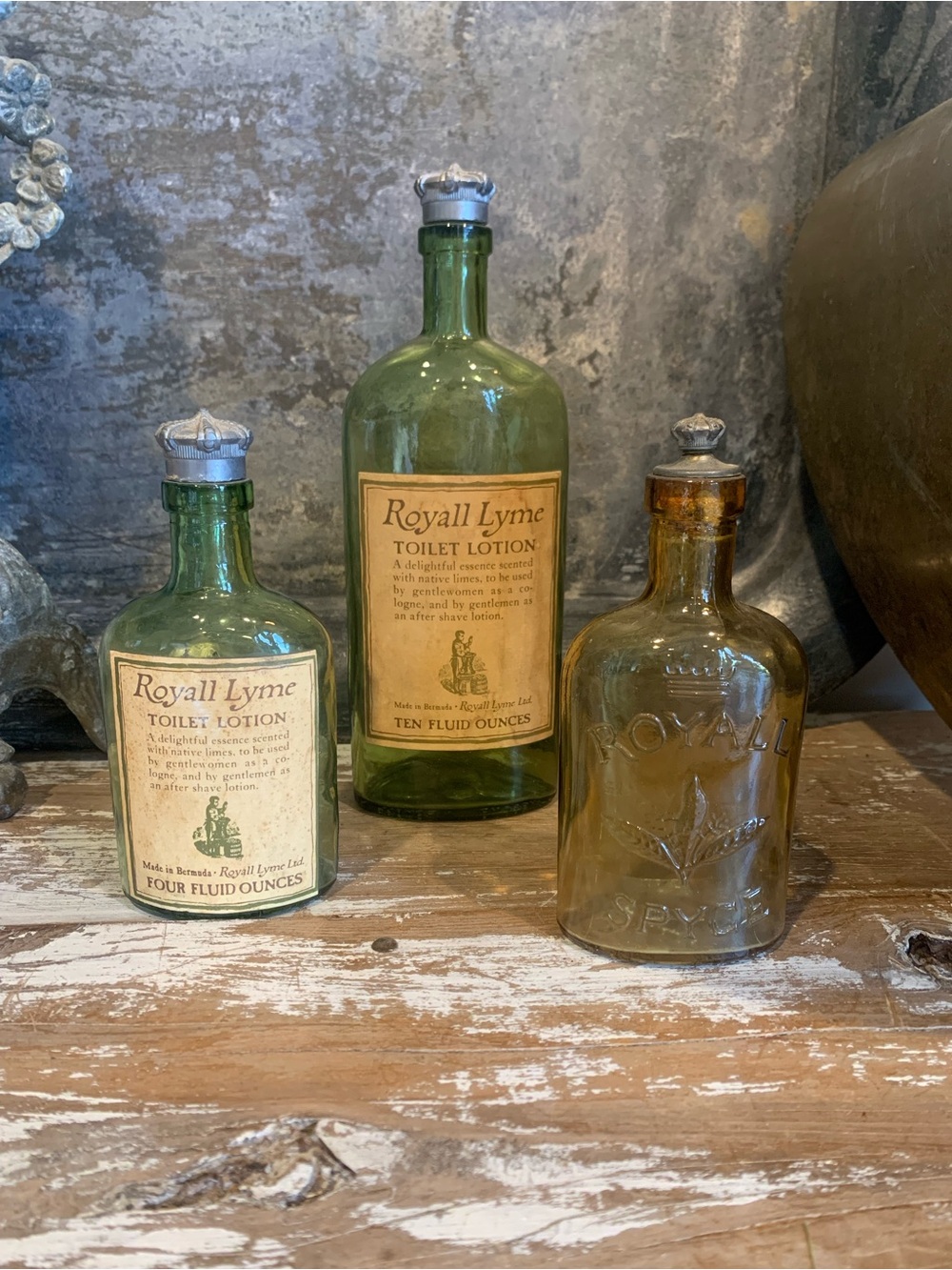 Vintage Royall Lyme Green Glass Toilet Lotion Bottles plus an amber bottle.